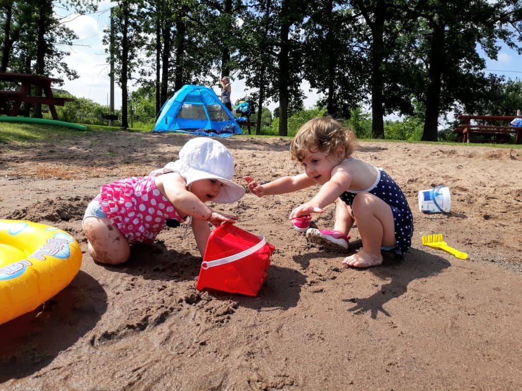 toddlers playing on the beach