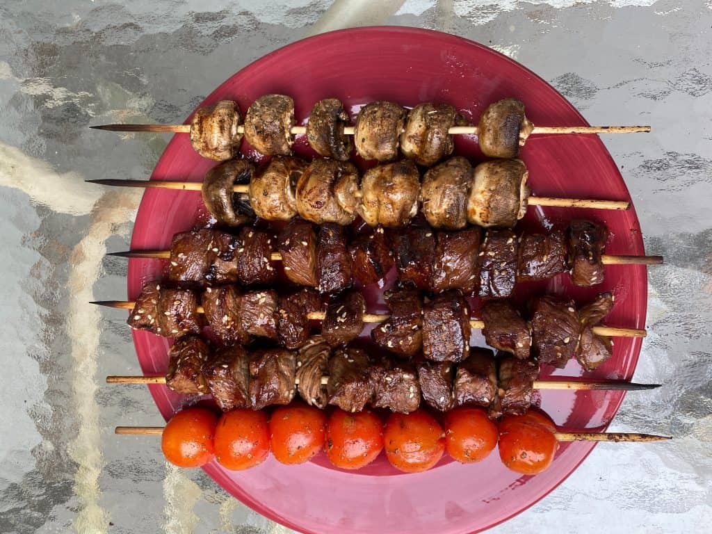 skewers of steak, mushrooms, and cherry tomatoes