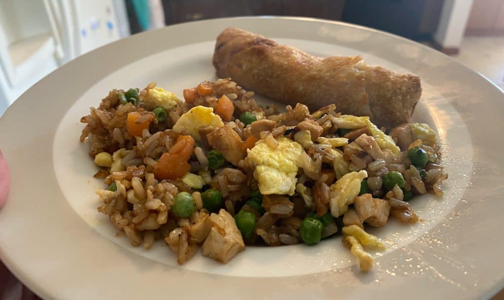 plate of chicken fried rice and an egg roll