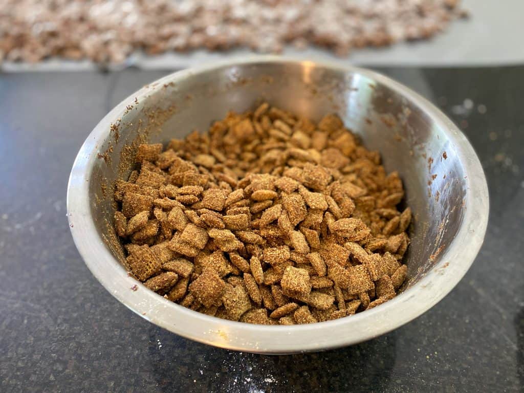 mixing bowl of puppy chow coated in graham cracker crumbs