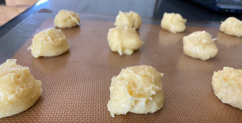 pastry dough portioned onto baking sheet