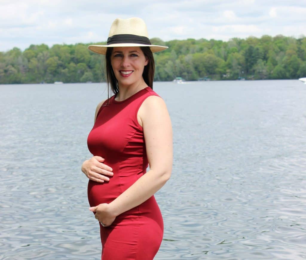 picture of author by lake cradling baby bump
