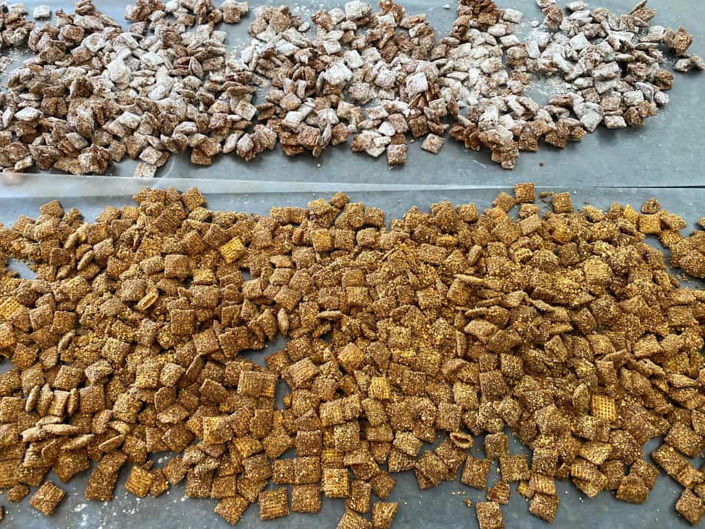 puppy chow spread out on wax paper