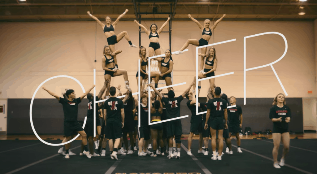 cheerleaders in a pyramid with the word cheer overlayed