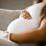 pregnant woman holding her stomach