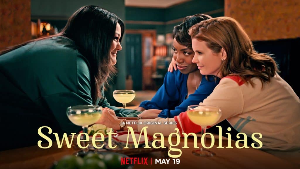 three women looking at each other fondly with margaritas