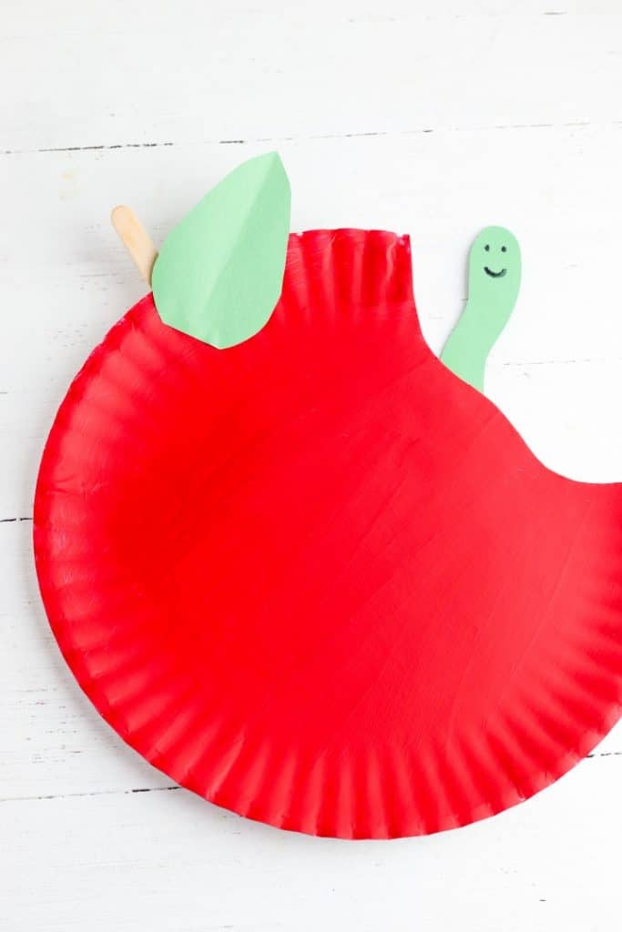 red colored paper plate with head of a caterpillar coming out