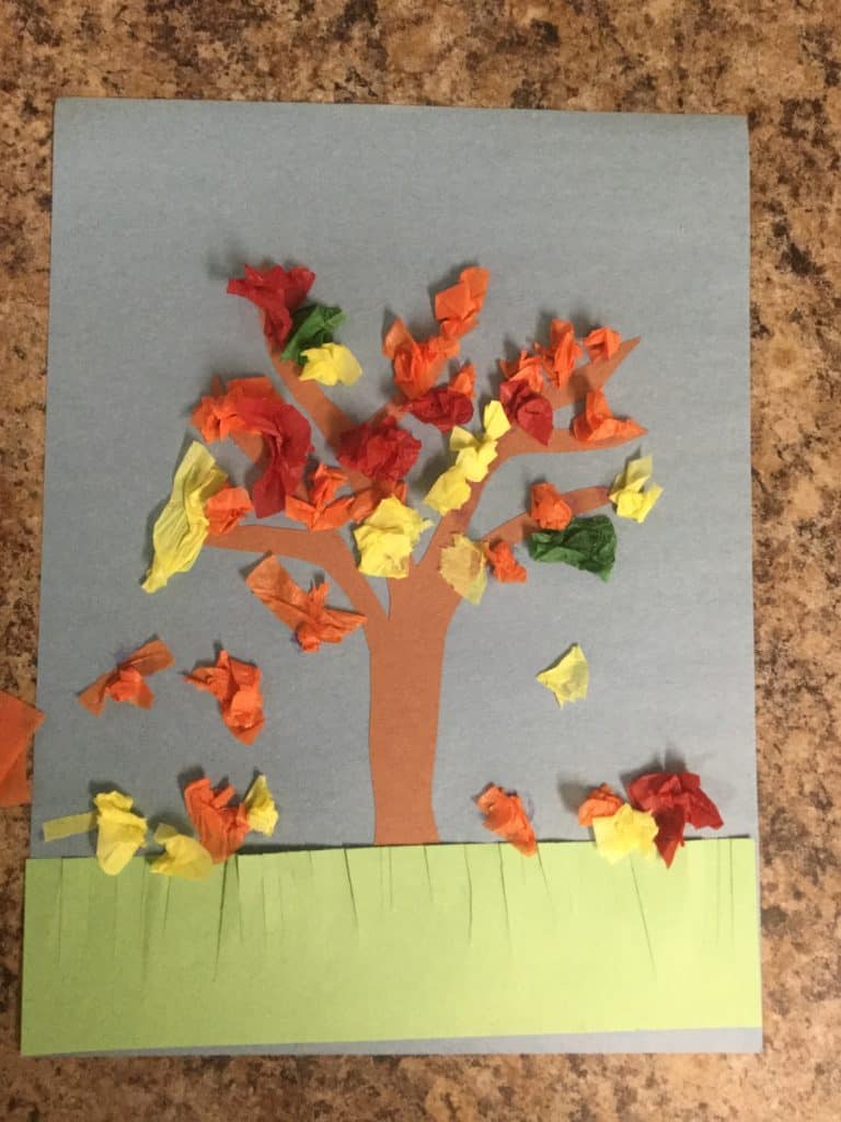 construction paper tree with crumpled up tissue paper as leaves