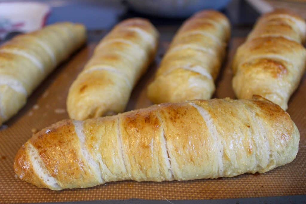 baking sheet with baked pretzel dogs on top