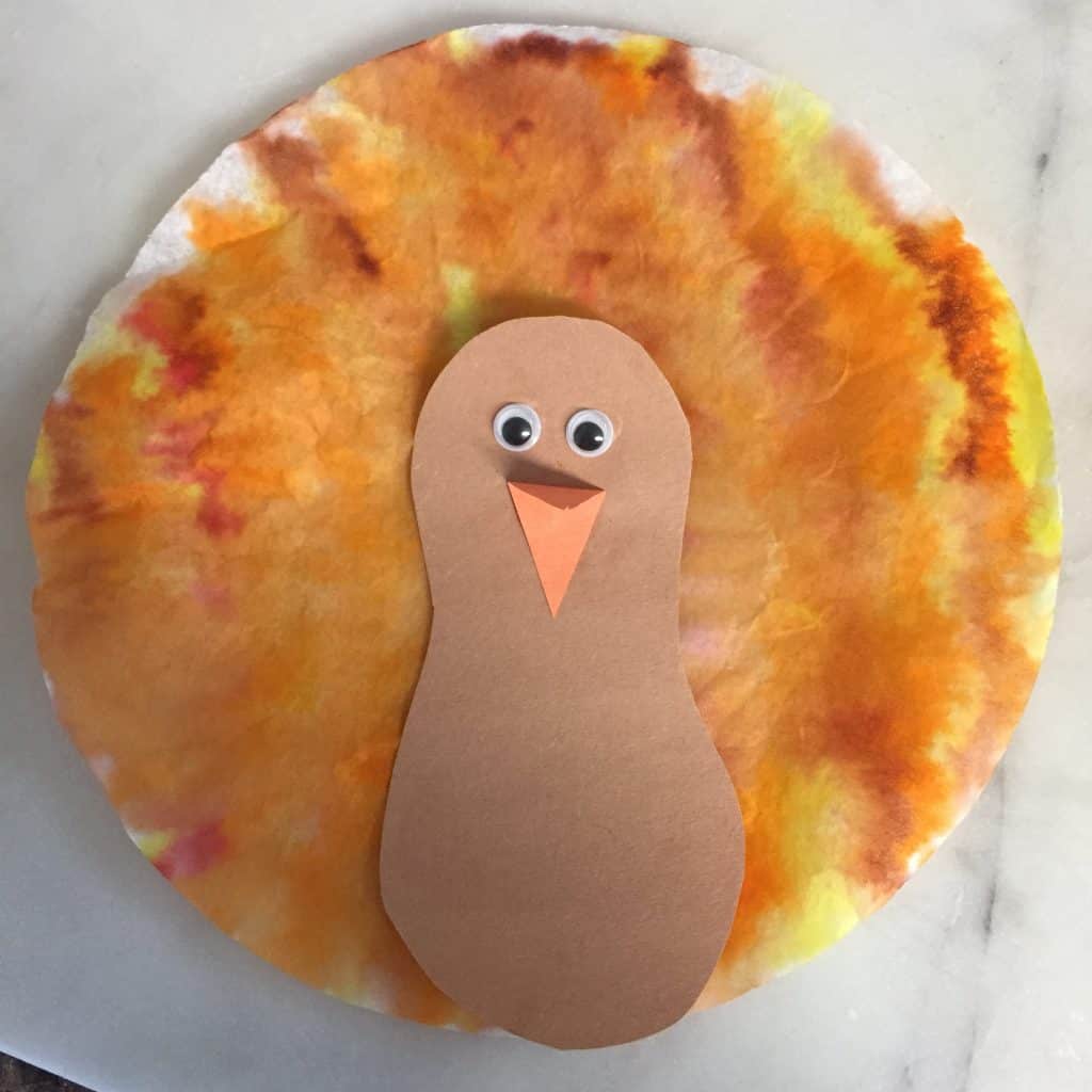 construction paper turkey with a tie dyed colored coffee filter as a tail