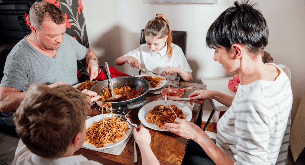 family of four eating spaghetti