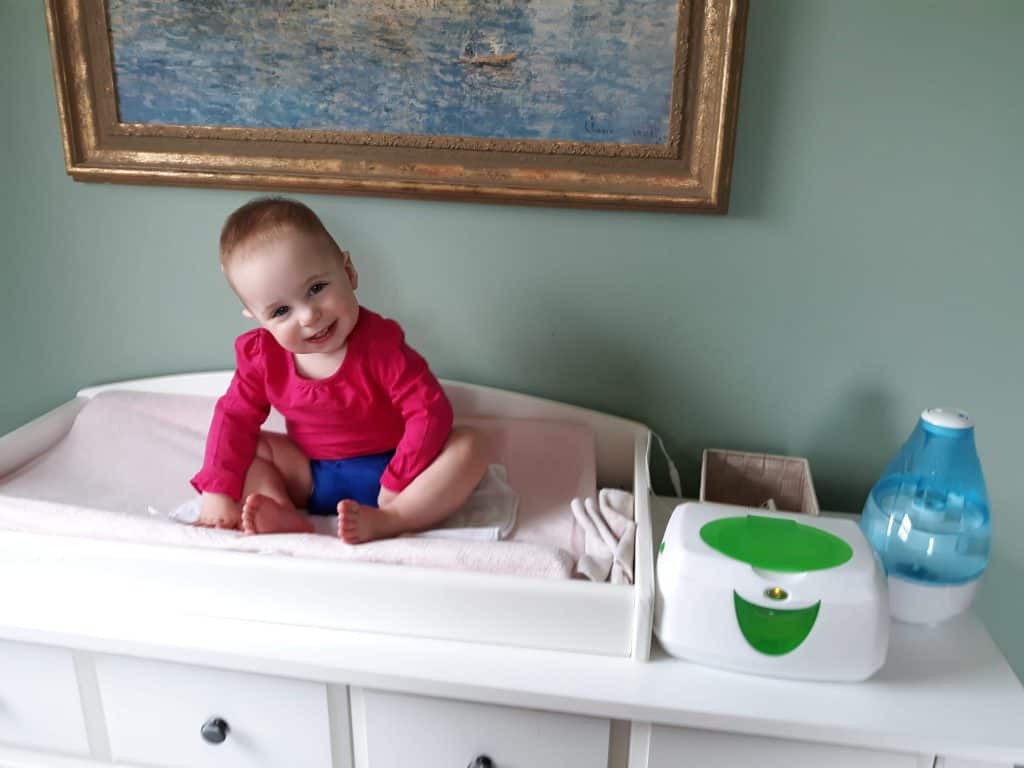 toddler wearing cloth diaper on changing table