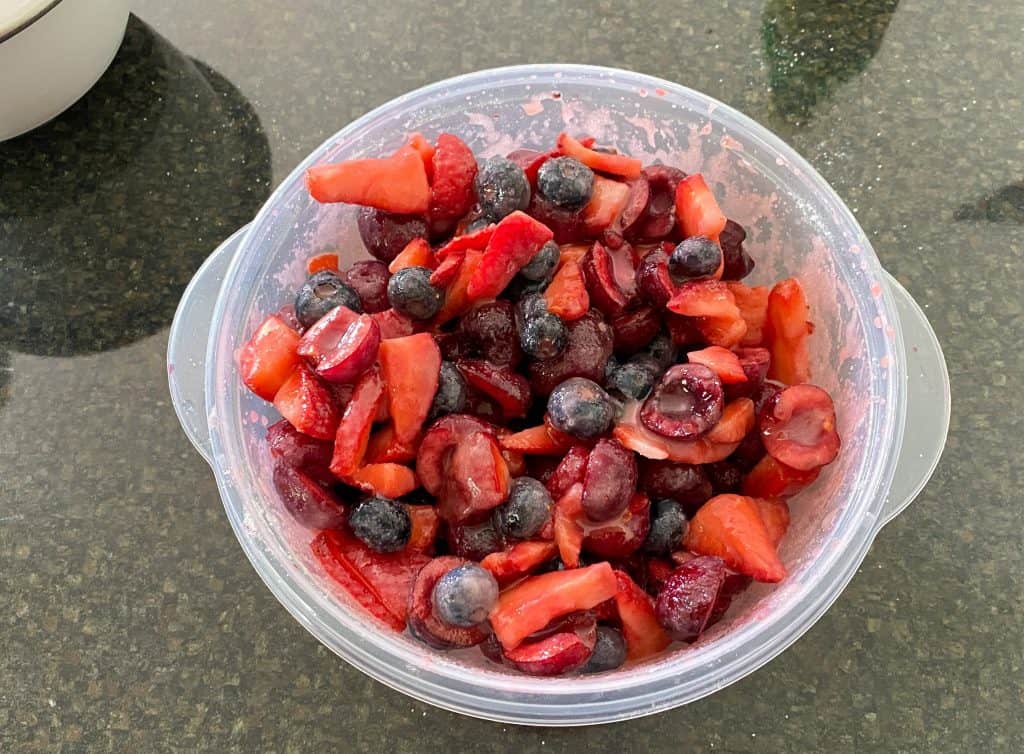 bowl of mixed berries with sugar on top