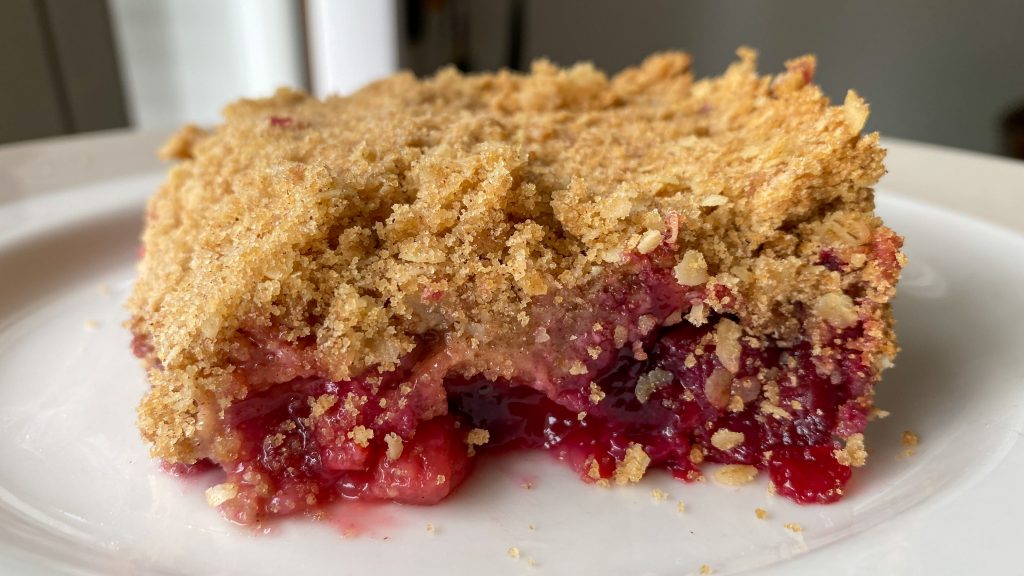 a square of cherry berry crisp on a plate