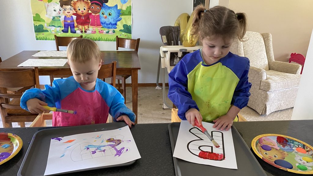 toddlers painting "r" for rainbow