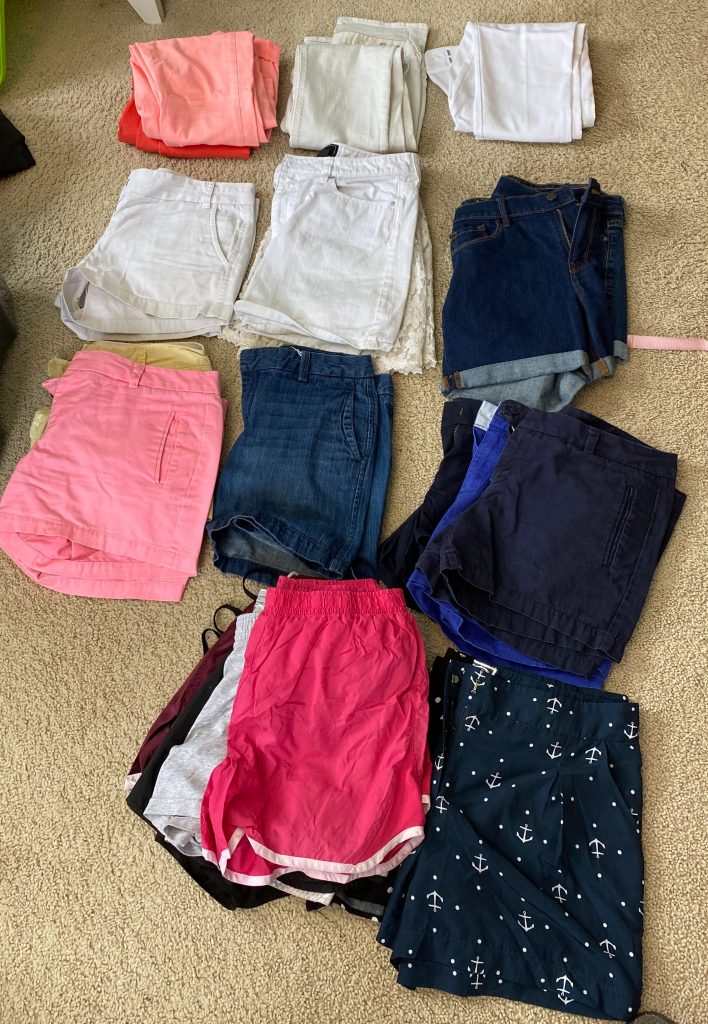 eight piles of shorts and pants
