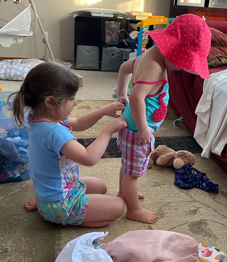 two girls trying on summer clothes