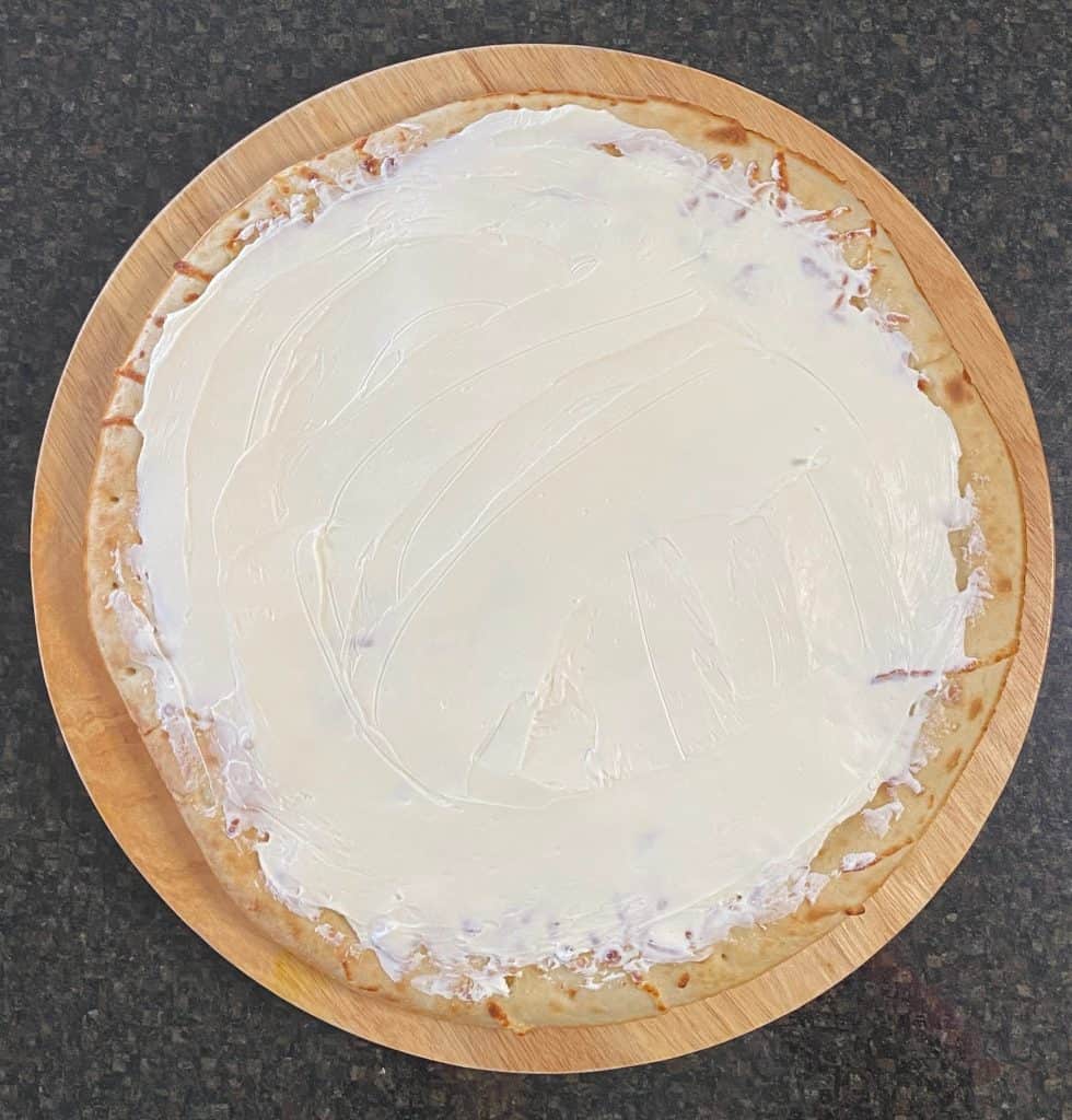 cream cheese spread on top of the pizza crust
