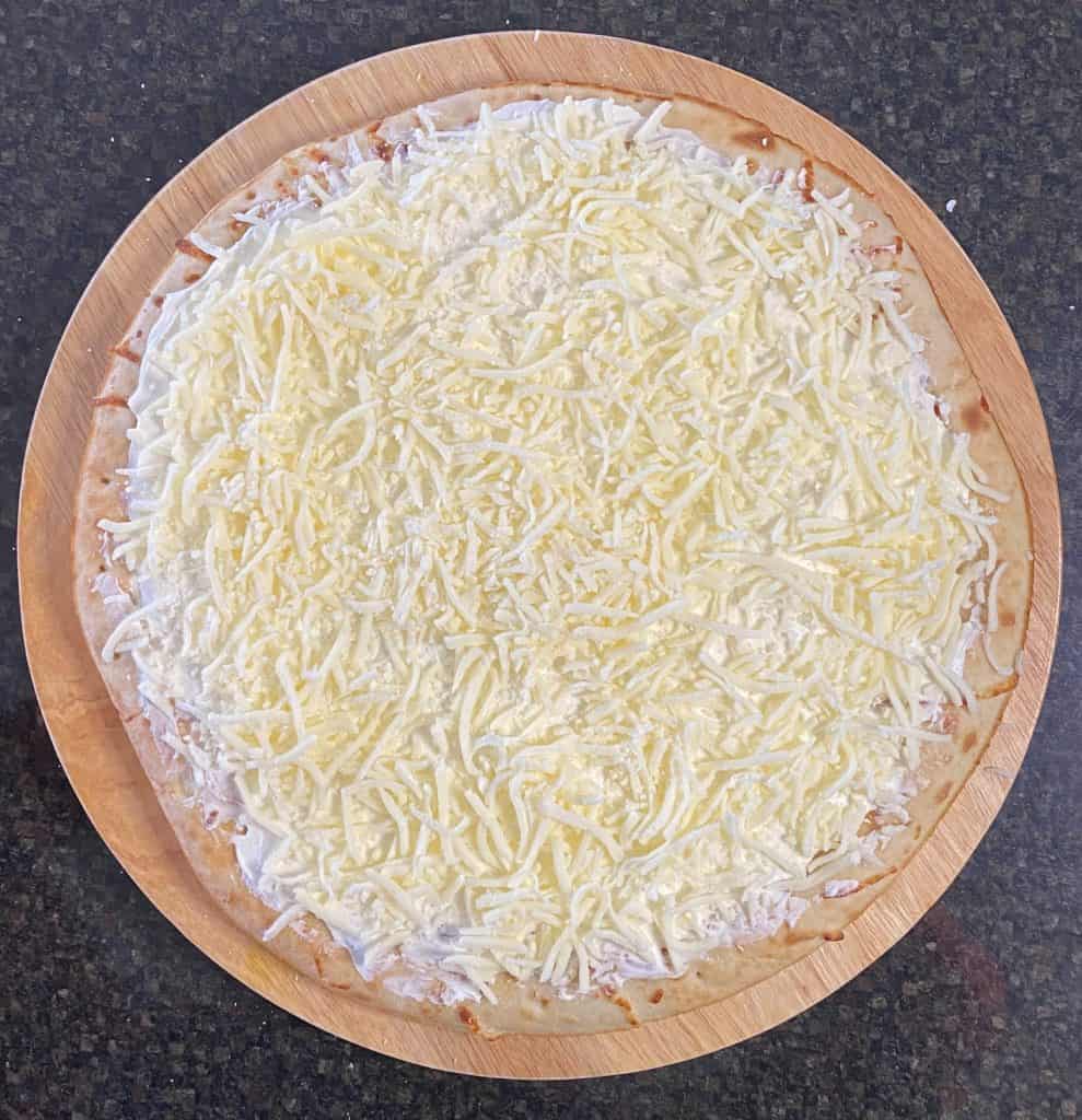 shredded mozzarella cheese sprinkled on top of cream cheese