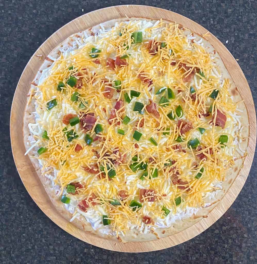 cheddar cheese sprinkled on top of the toppings