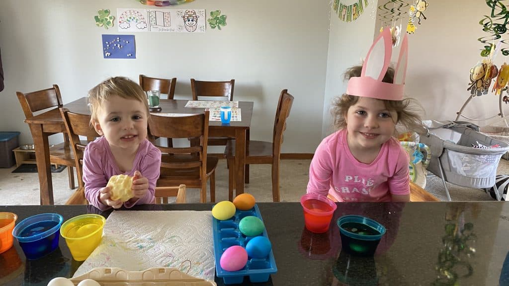 two kids dying Easter eggs