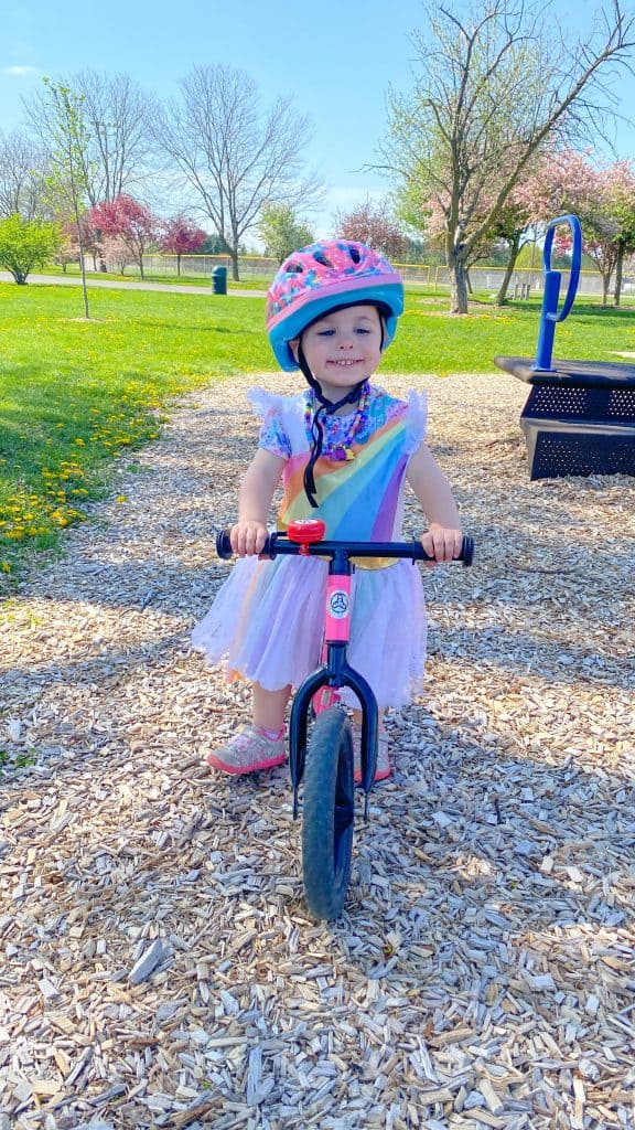 little girl on a balance bike