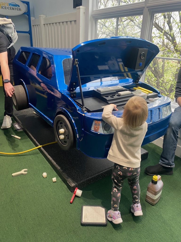 playing car maintenance at the children's museum