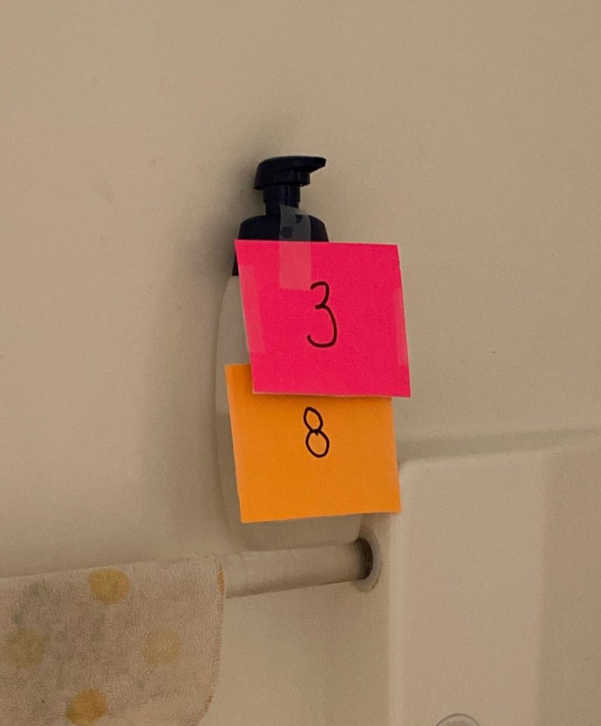 Clues for two different groups taped to a shampoo bottle