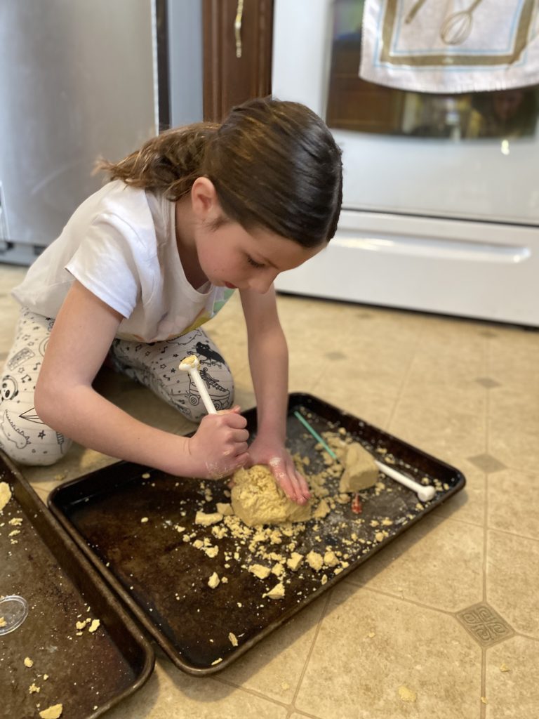 a child mining into a brick looking for gems