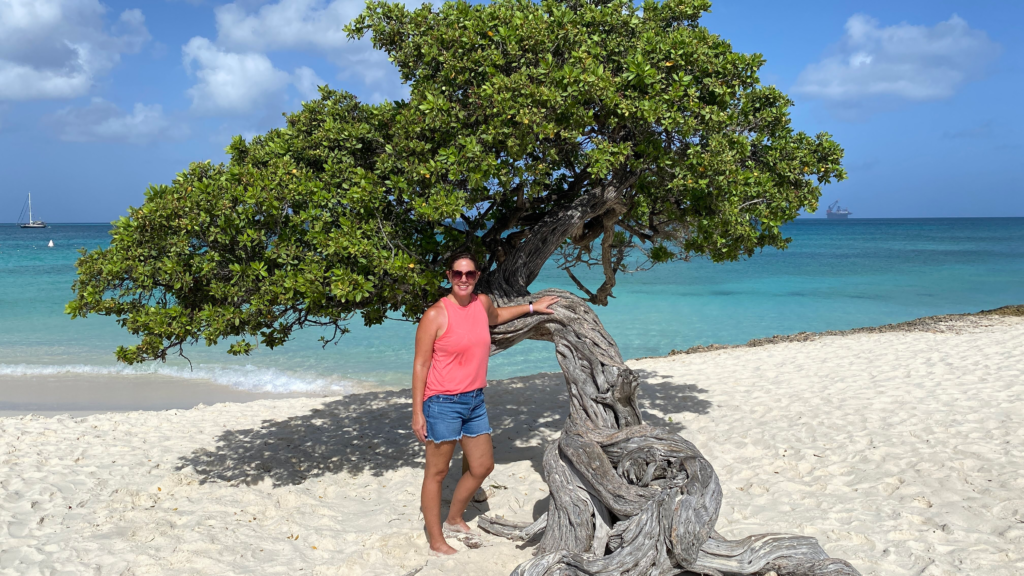Blog author standing by tree in Aruba