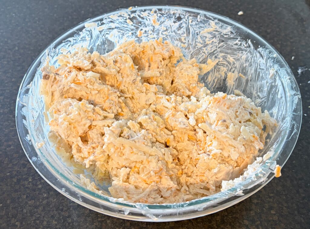 large bowl of hash brown casserole mixture