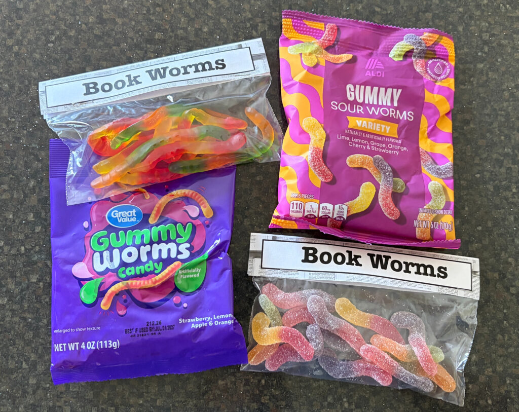 bags of gummy worms, sweet and sour, with the heading "book worms" stapled on top