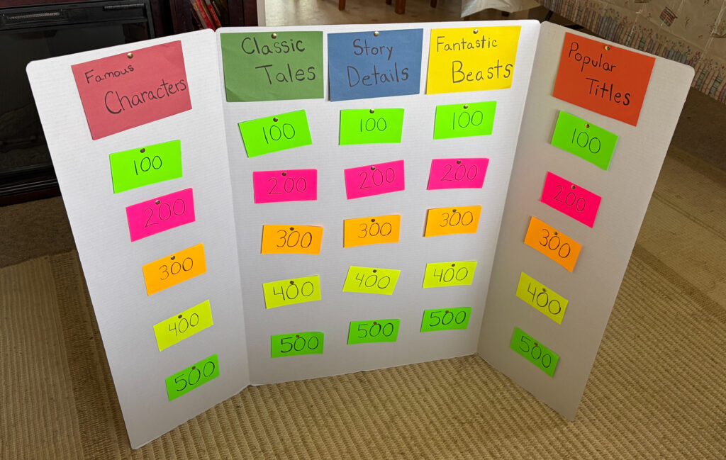 Book Themed Jeopardy game on white tri-fold board with neon index cards